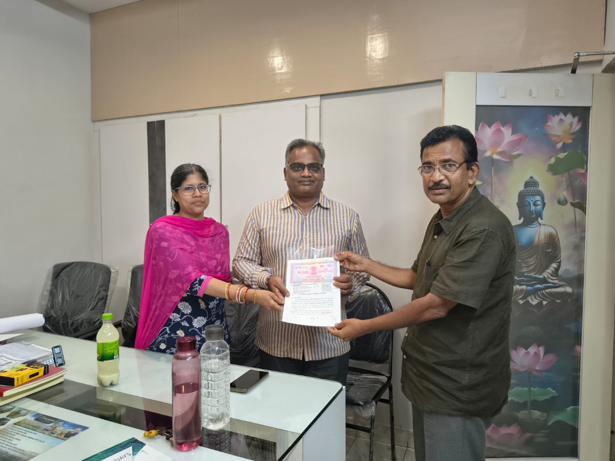 Customers receiving their plot documents at the Kaladhar Infra office