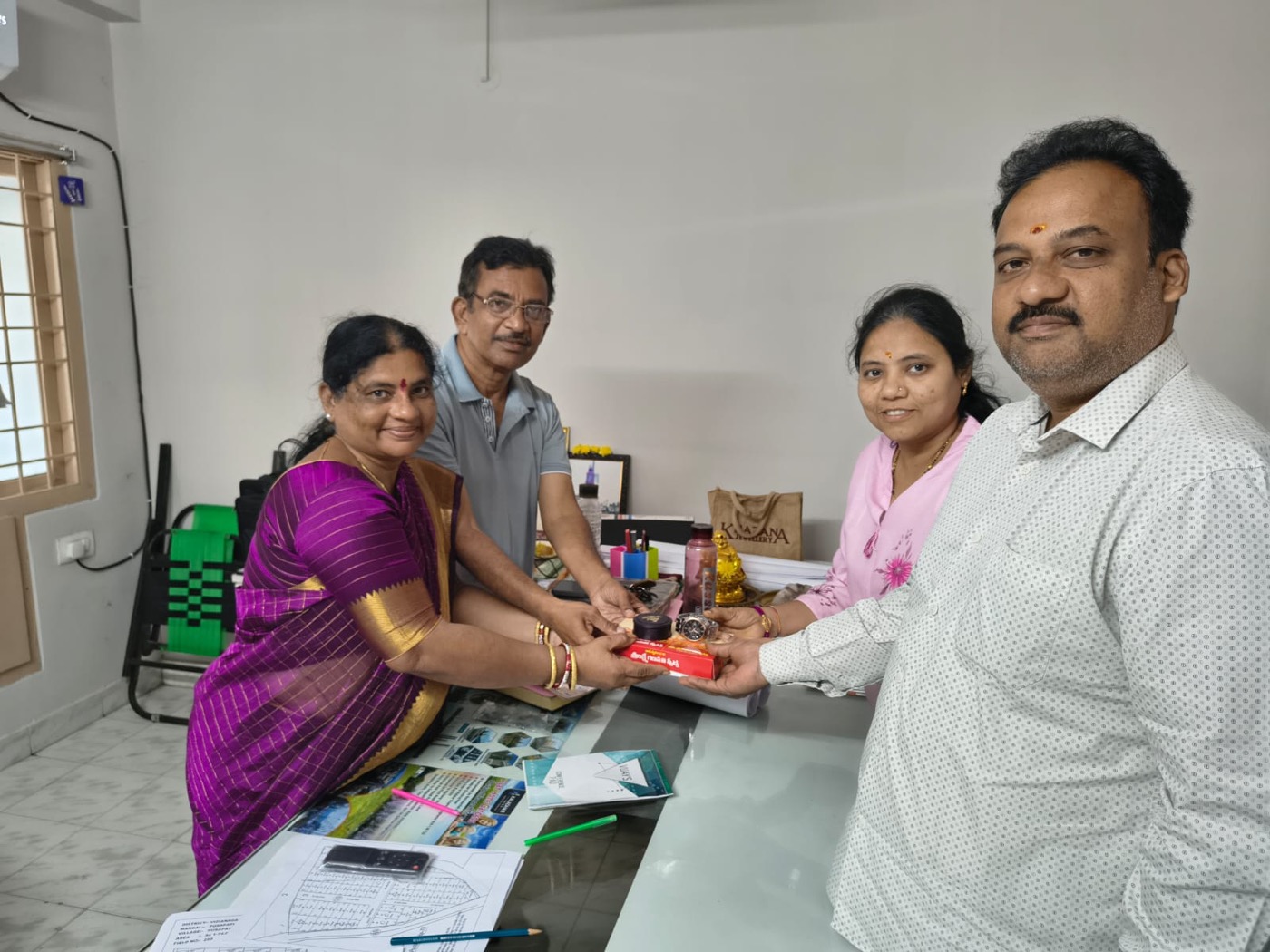 Customers at the Kaladhar Infra office in Dwarakanagar after completing their booking